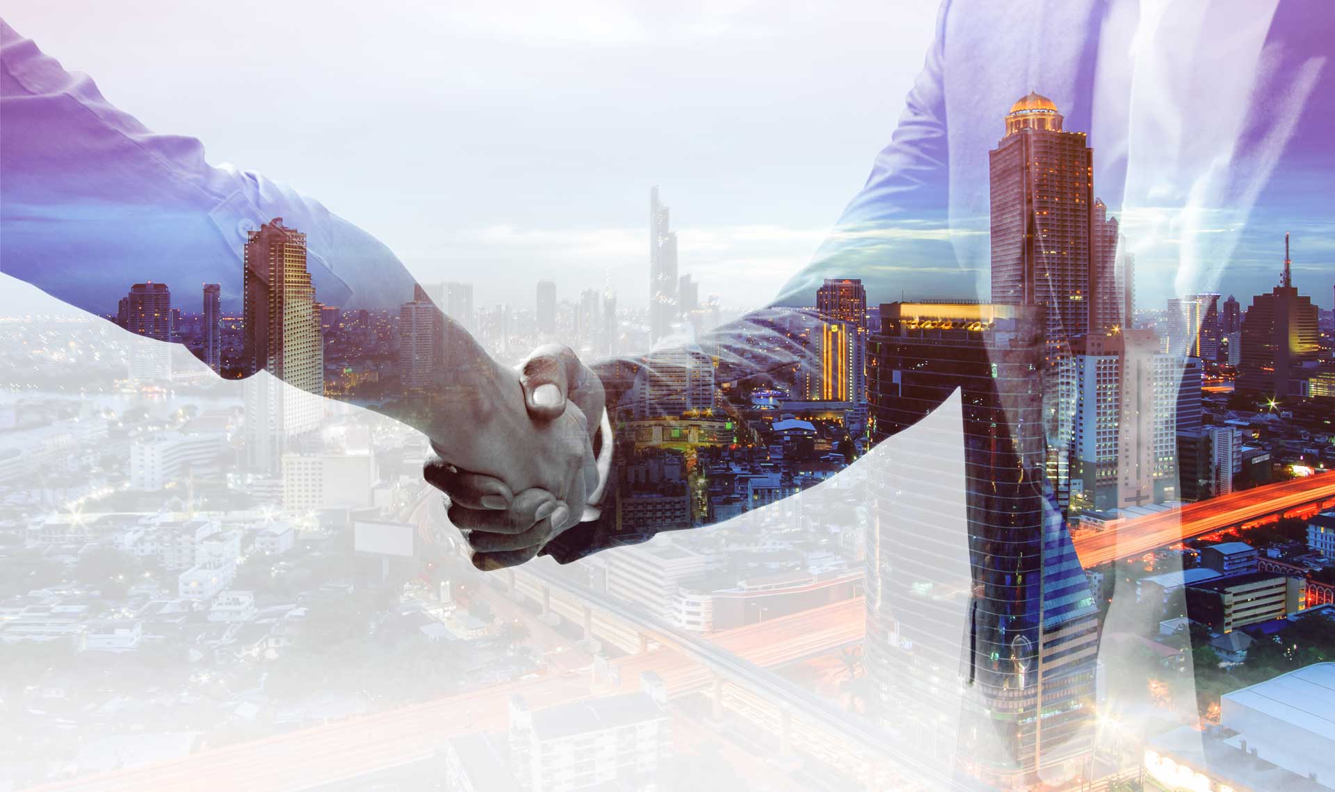 2 hands shaking with double exposure of office buildings