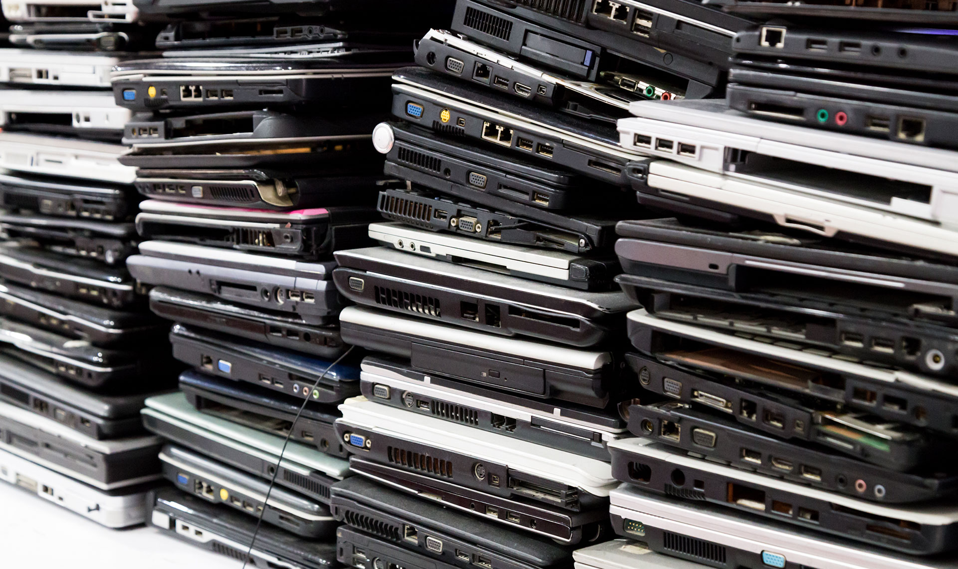 Stacked pile of old laptops
