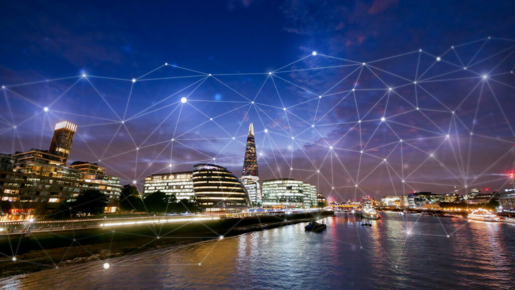 Modern office buildings in London with digital network overlay, symbolising cloud adoption and the ongoing value of secure IT asset disposal
