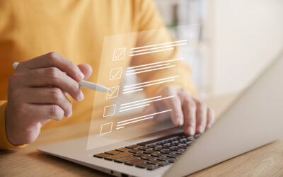 Person using a laptop with a digital checklist overlay, representing IT asset disposal management and compliance in the context of ITAD services.