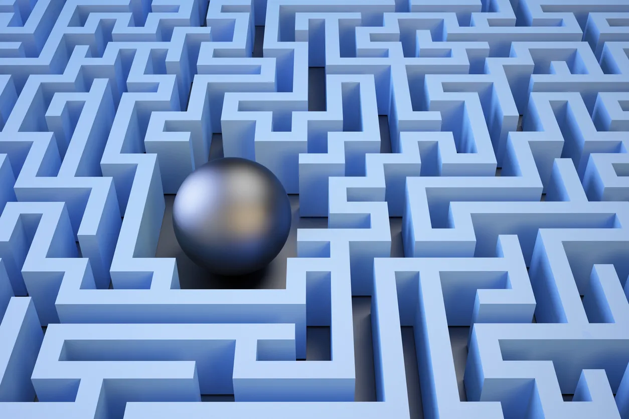 3D blue maze with a reflective silver ball positioned at a pathway intersection, symbolizing strategic navigation in IT asset resale and transformation processes.