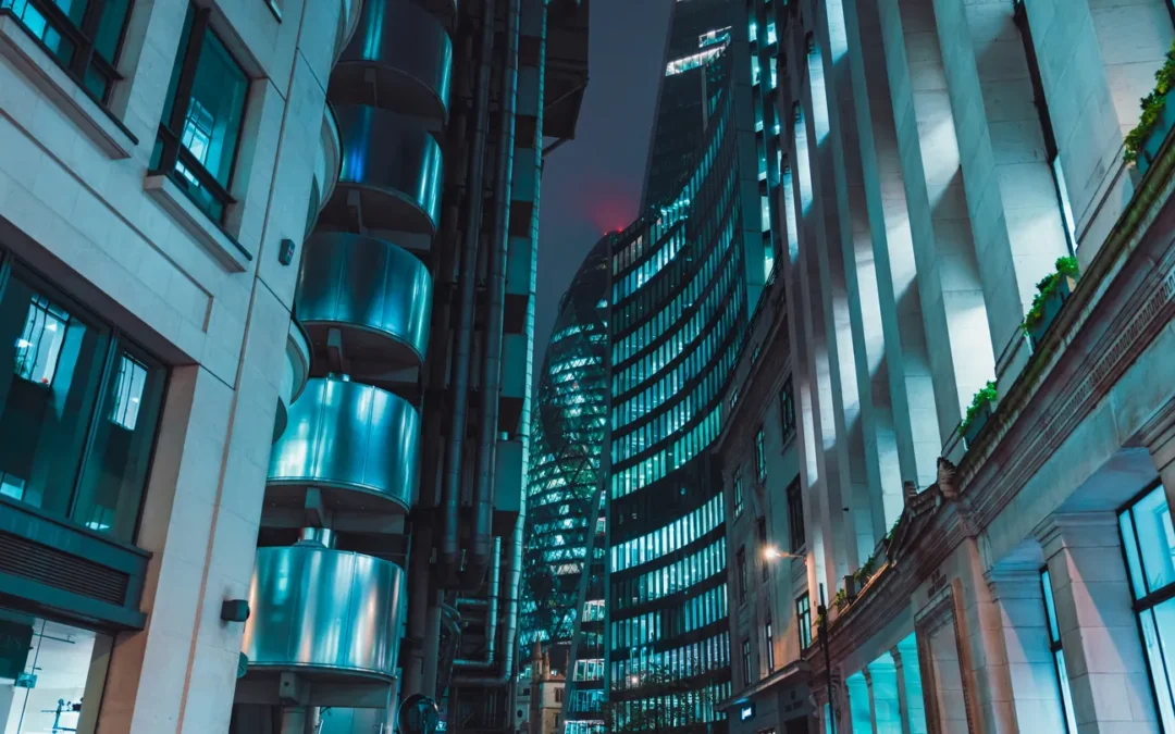 London cityscape at night featuring modern skyscrapers and illuminated buildings, reflecting the technological landscape relevant to secure data destruction and IT compliance.