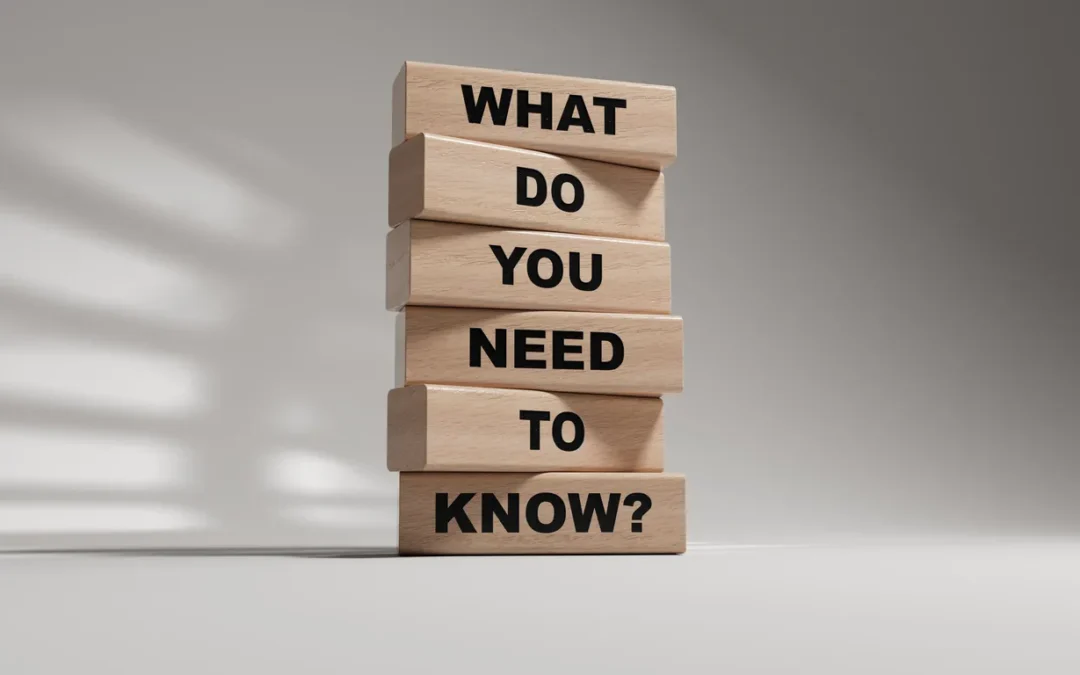 Wooden blocks stacked vertically with the text "WHAT DO YOU NEED TO KNOW?" in bold, representing essential information for data centre relocation and IT asset management.