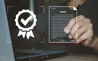 Person signing a document next to a verified certification icon, illustrating compliance and security in IT asset disposition.