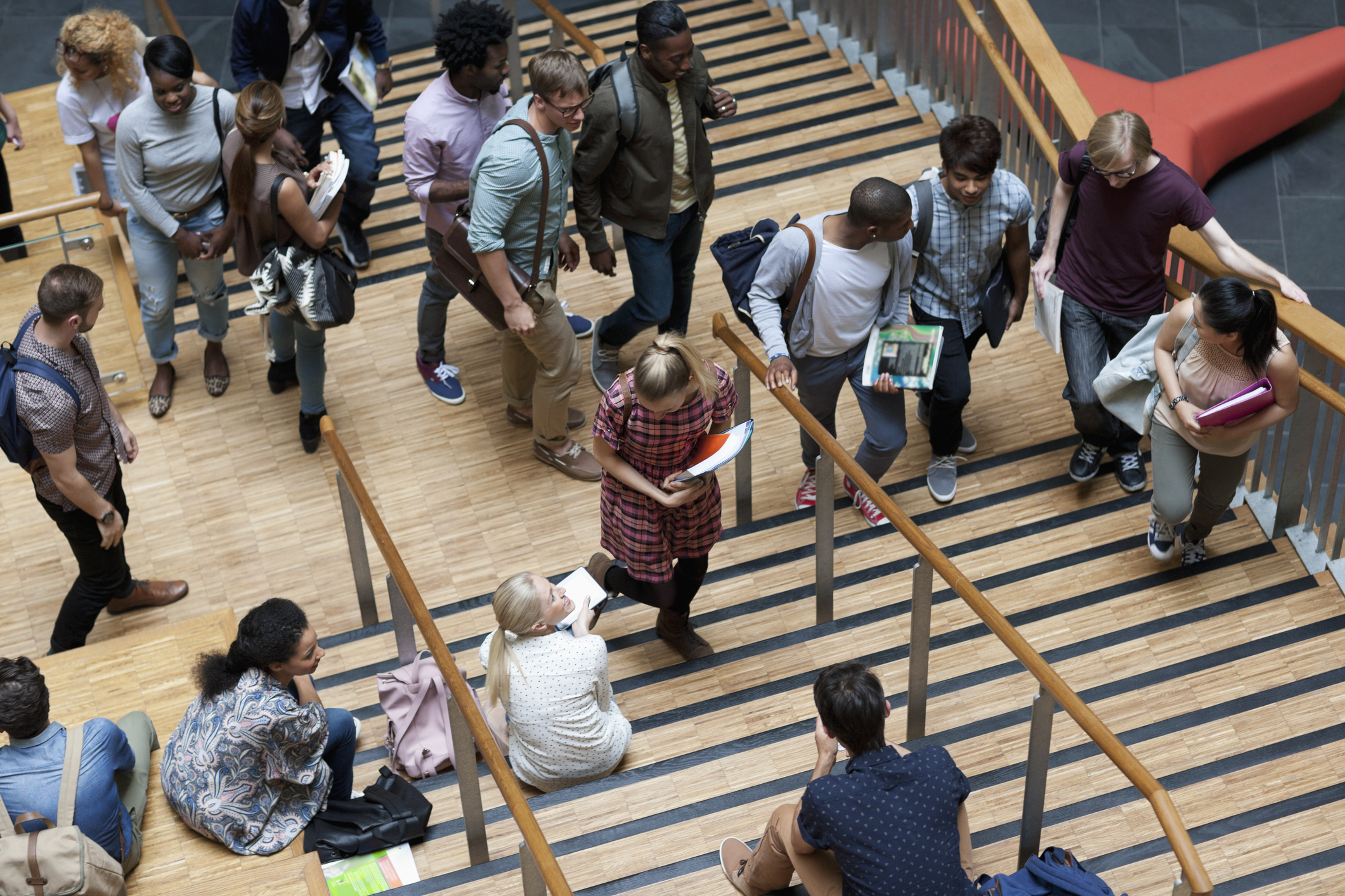 Students walking through a modern university campus between lectures.